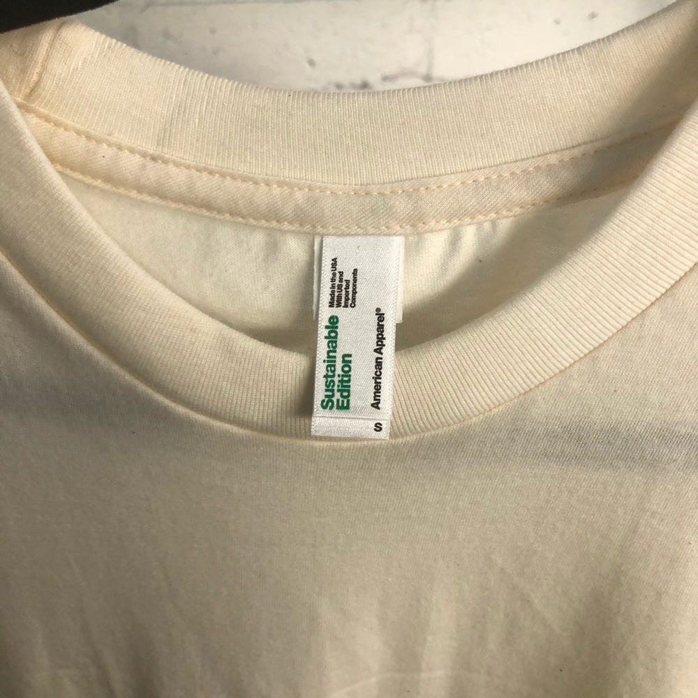 T-shirt. Color is off white or cream colored